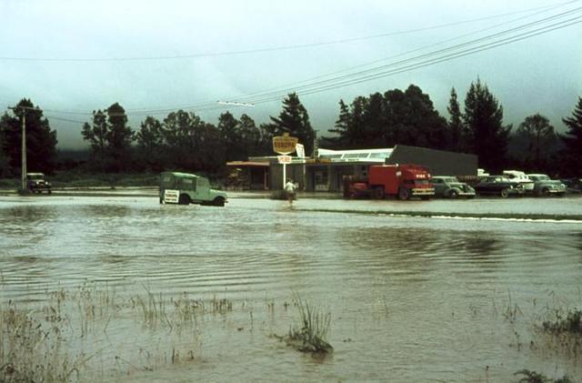 Tongariro River in flood, garage and shops